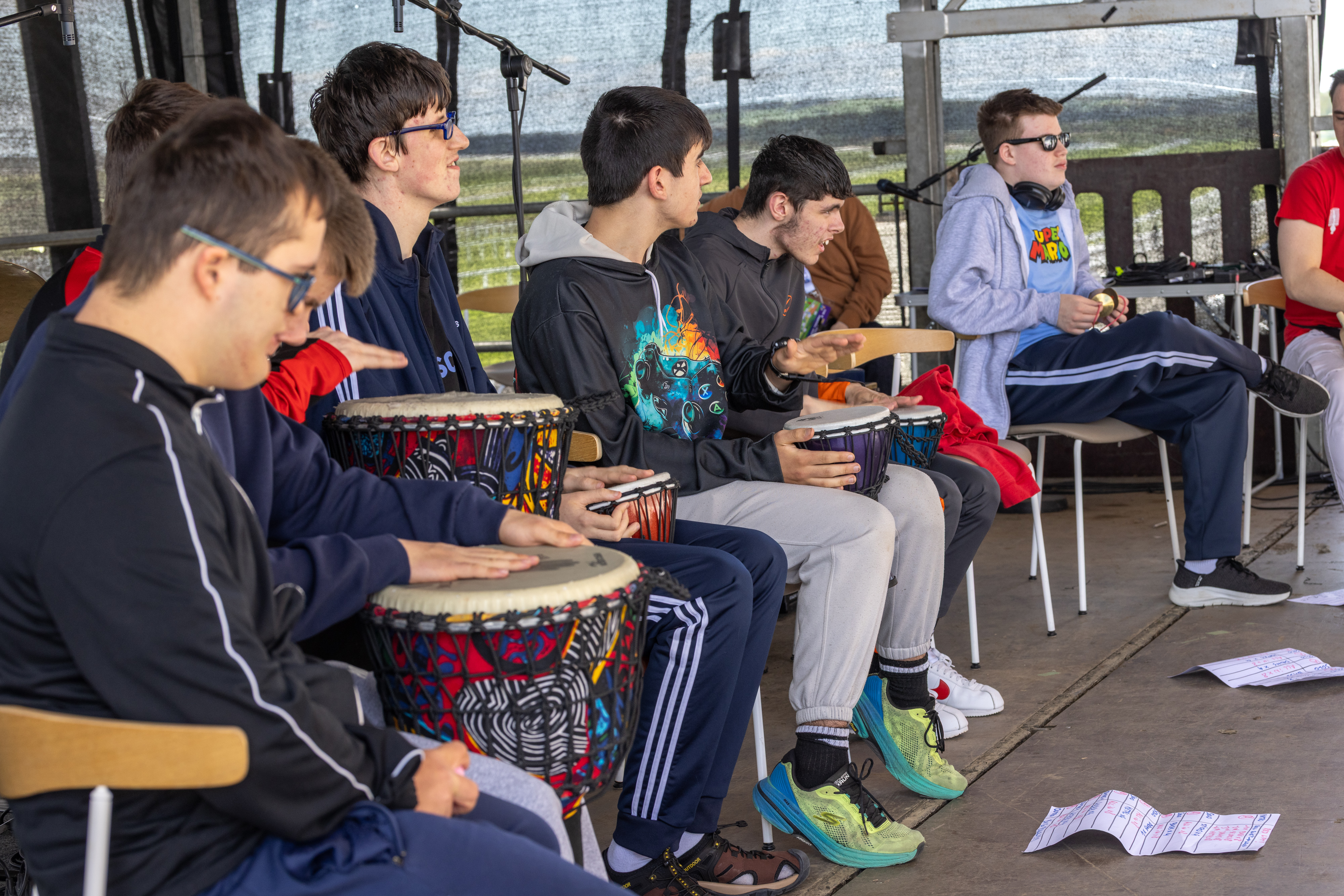 People playing drums on stage. 